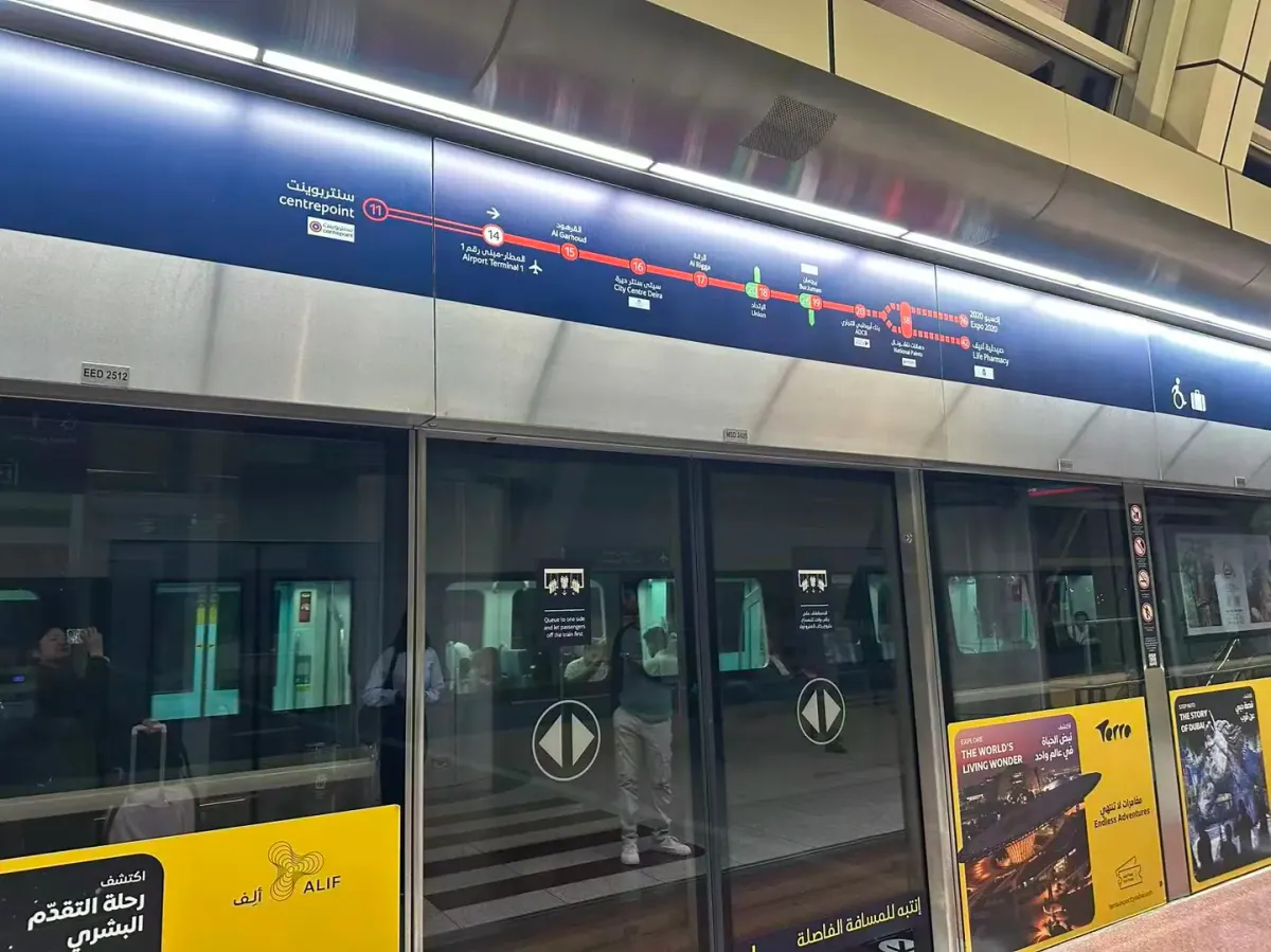 The Red Line diagram above the platform screen doors, listing stations from Centrepoint towards Burj Khalifa/Dubai Mall