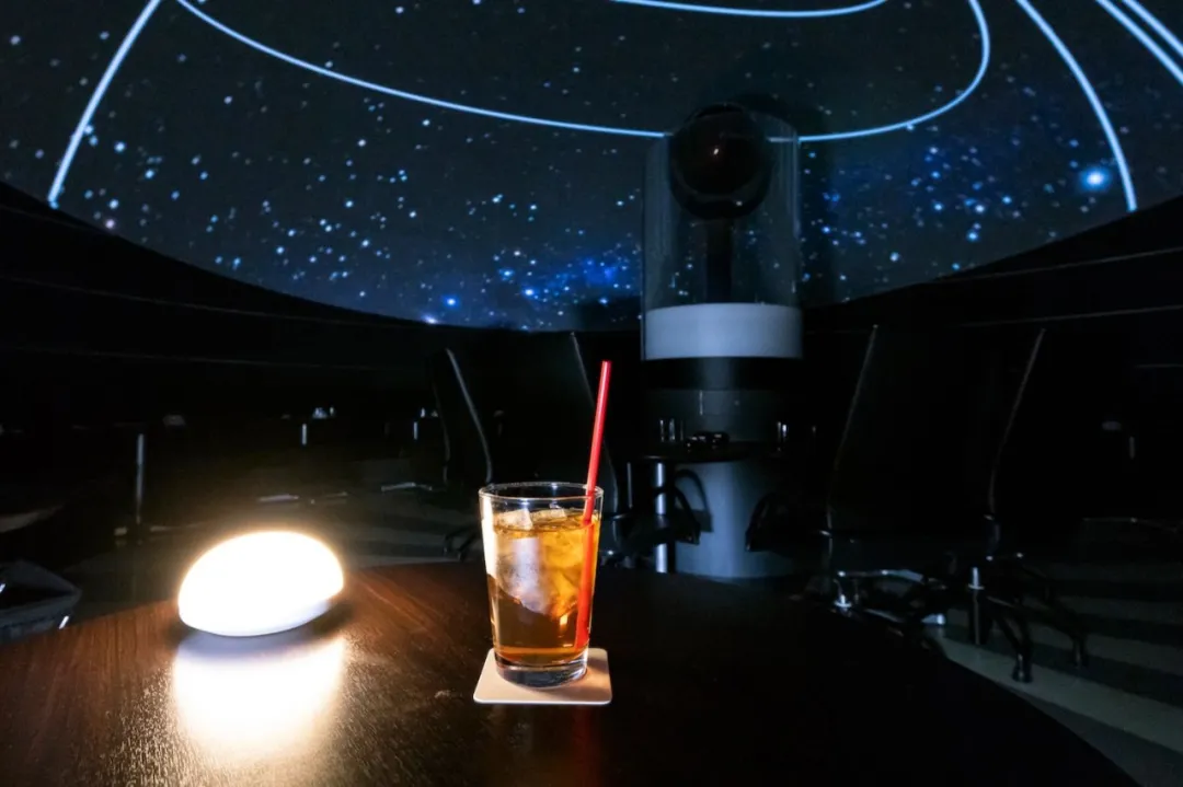A drink under the projected night sky at Starry Cafe