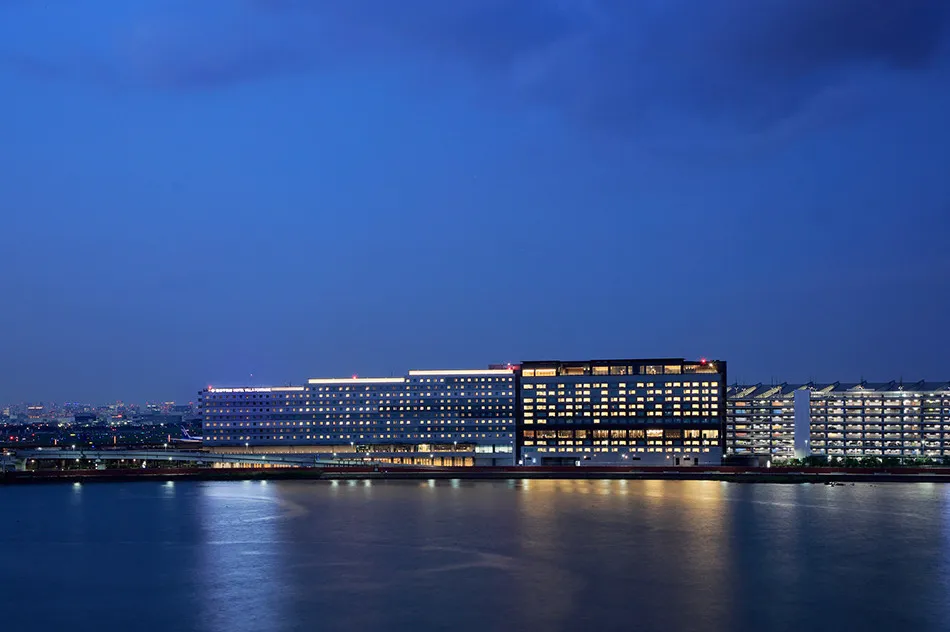 Haneda Airport Garden lit up at night across the water