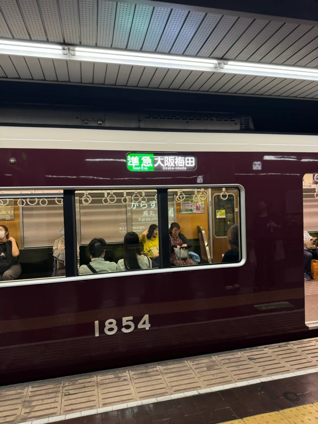 A Hankyu train at the platform, front display reading semi-express for Osaka-Umeda