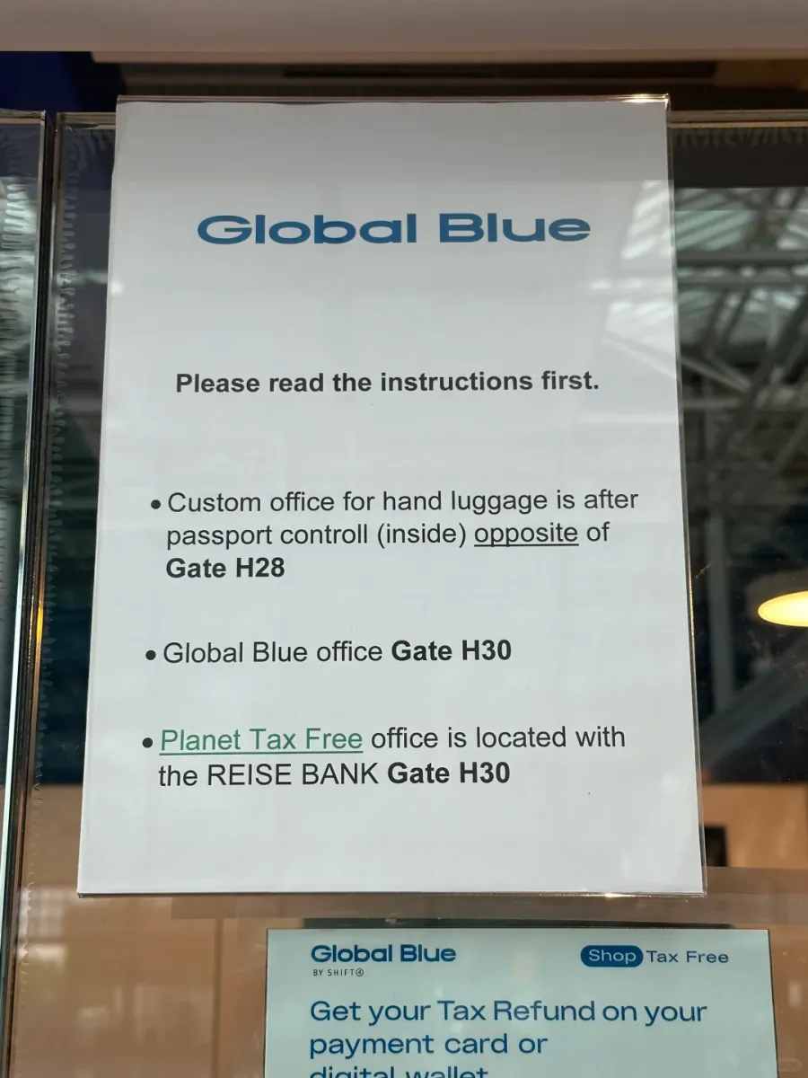 A Global Blue notice giving locations: the hand-luggage customs office after passport control inside or opposite gate H28, the Global Blue office at gate H30, and Planet Tax Free with Reise Bank at H30, with refunds to card or digital wallet
