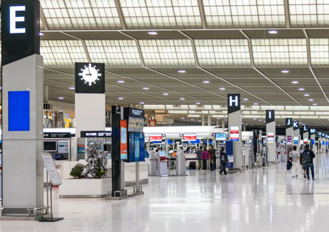 Check-in islands and flight information screens in the departures hall of Narita Airport Terminal 1