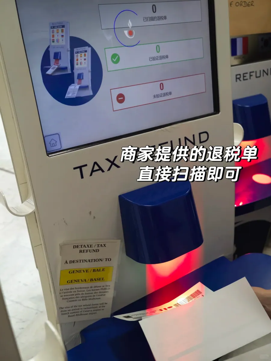 A close-up of the red scanning slot on a DETAXE kiosk: a hand feeds the barcode on a refund form into the reader while all three counters still read zero, and a small notice on the body reads À DESTINATION / TO GENÈVE / BÂLE
