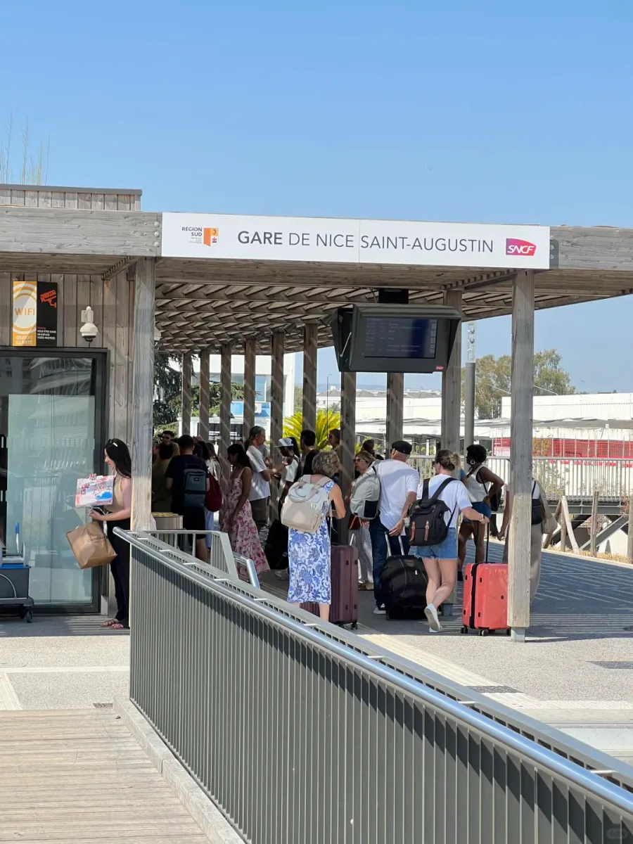 The entrance to the new Saint-Augustin station: passengers waiting under white steel canopies, with the station name on the board