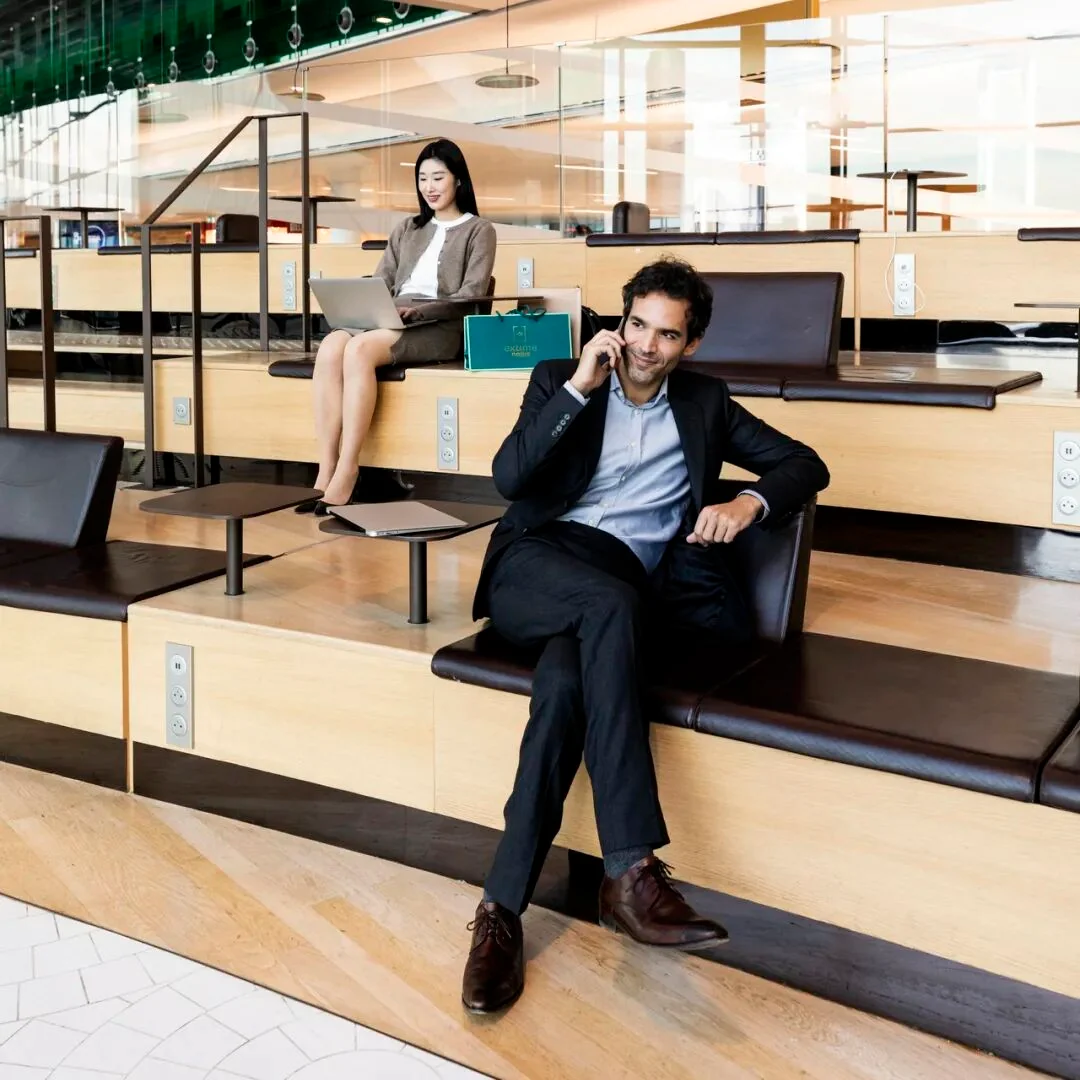 Tiered seating in a Paris CDG work zone, with small tables and power sockets