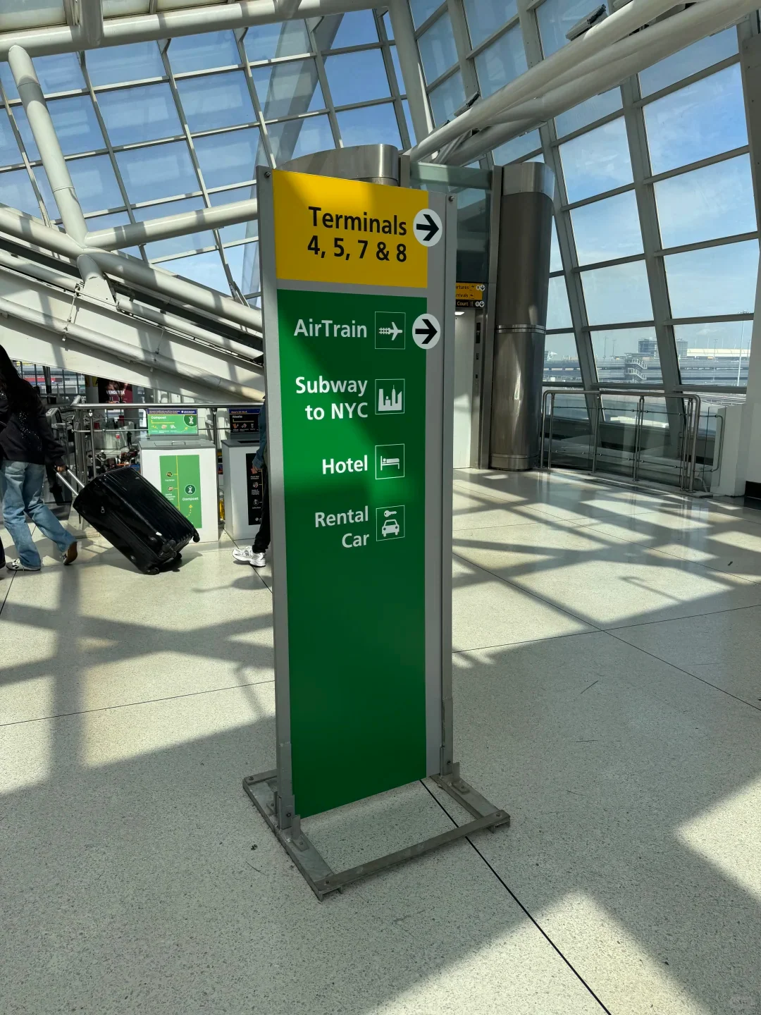 Signs at JFK Terminal 1 for the AirTrain and the subway into New York