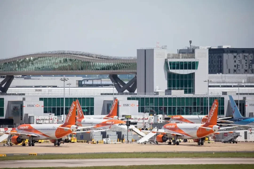 easyJet aircraft on the apron at Gatwick, with the terminal and its bridge behind