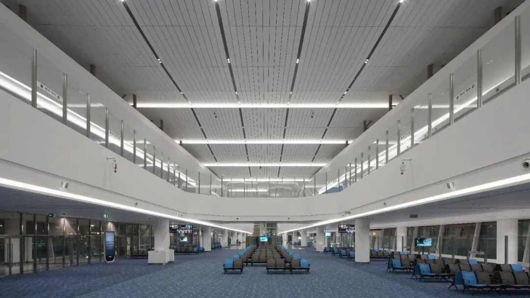 A pier at Terminal 5, with two levels of glass-fronted waiting areas above the gate lounge