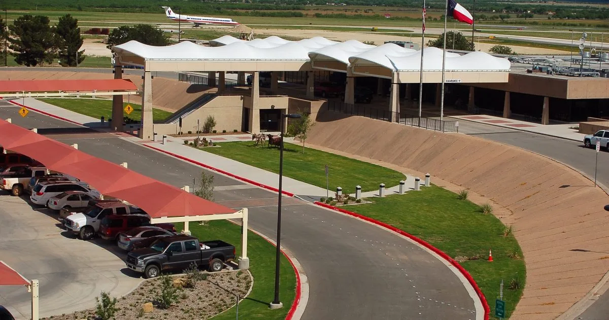 Luftaufnahme des Abilene Regional Airport: weiße, zeltartige Dächer über der Vorfahrtschleife, während auf dem Vorfeld ein Passagierflugzeug abgefertigt wird.