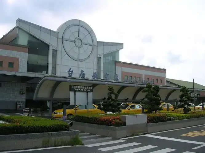The front of Tainan Airport's terminal, with its arched gable and the taxi stand in the forecourt.